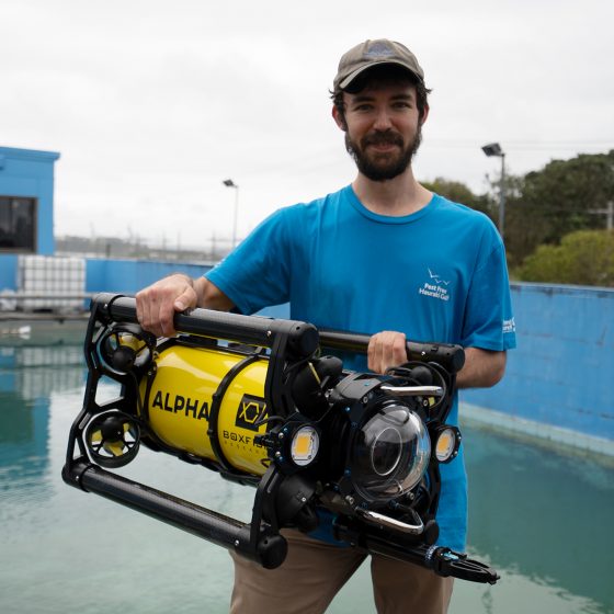 ROV pilot holding Boxfish Alpha with two hands
