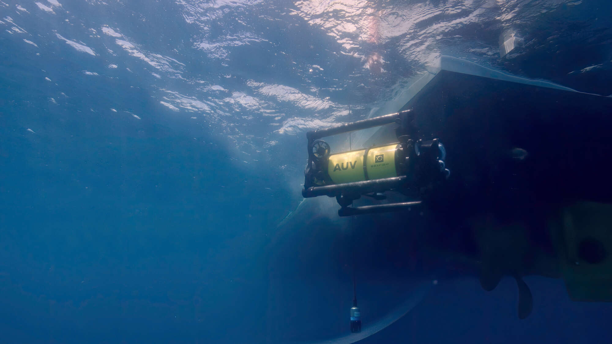 Boxfish AUV next to the boat and USBL